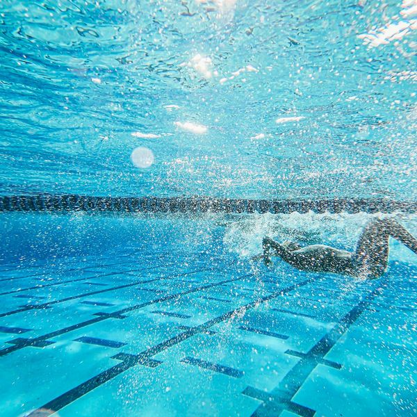 Person in a dynamic yet controlled movement, embodying the flow of exercise.